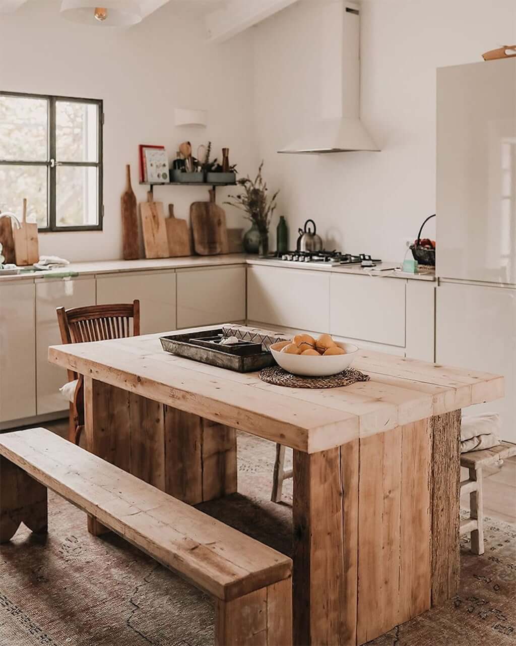 wood table in cream eat-in kitchen
