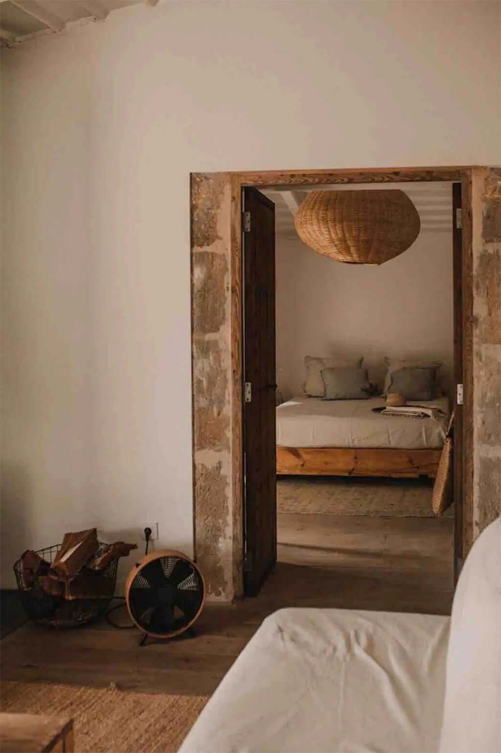 rustic bedroom with exposed stone doorway