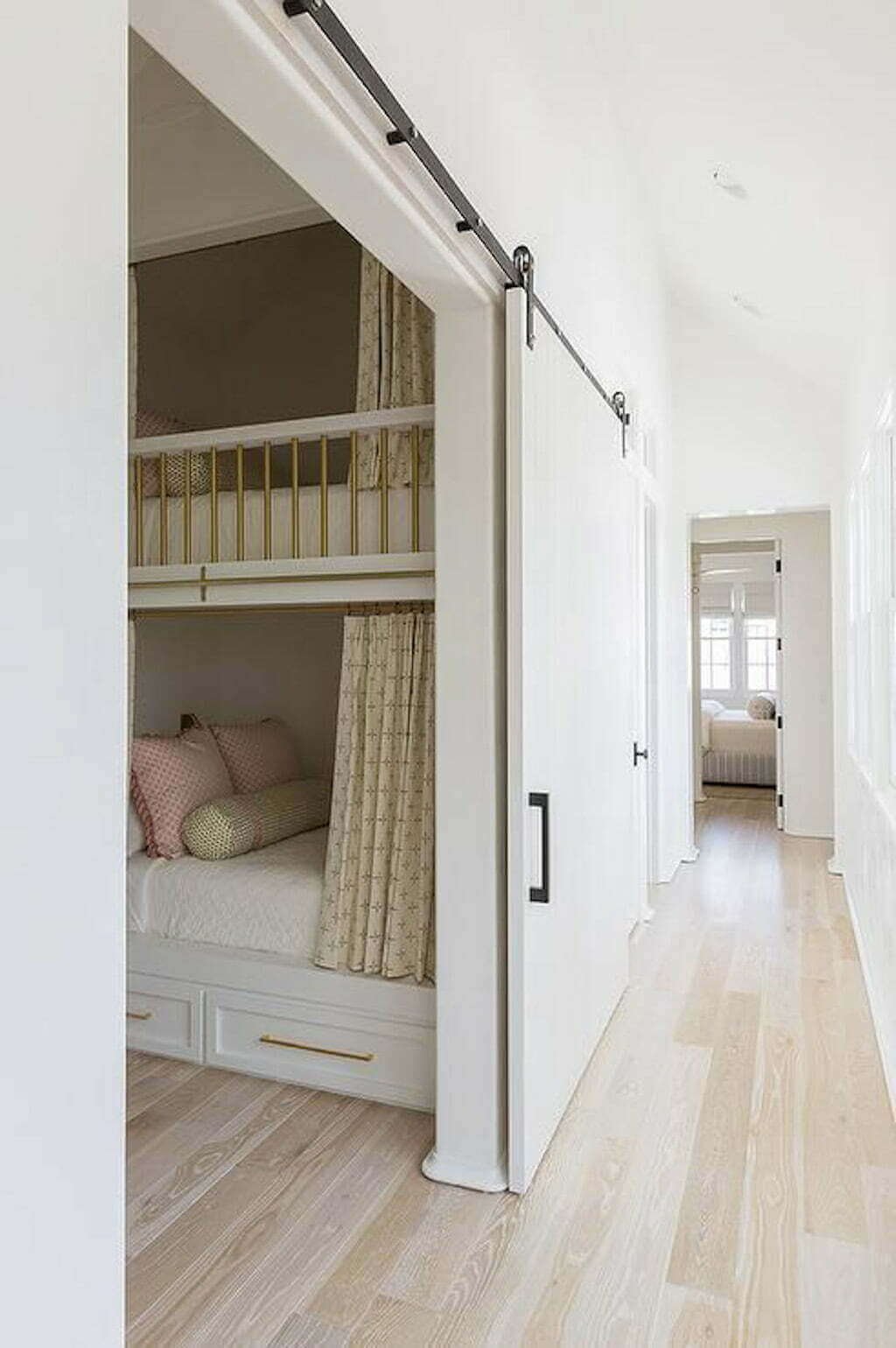 bunk room in modern beach house with sliding barn doors