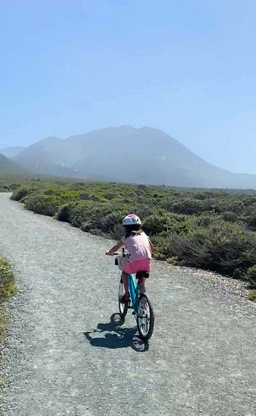 young girl with helmet biking in Montaña de Oro State Park