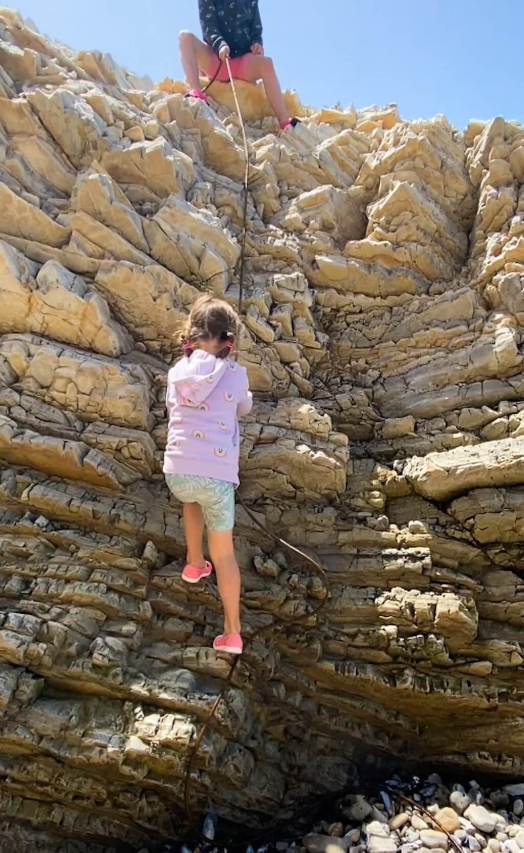 two children climbing rocks 