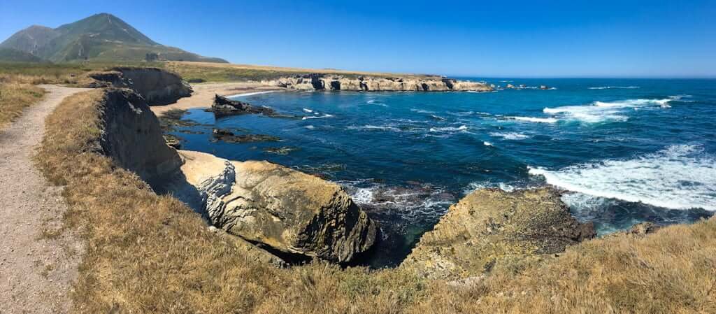 view from Montana de Oro Bluff Trail down to ocean with mountain in distance