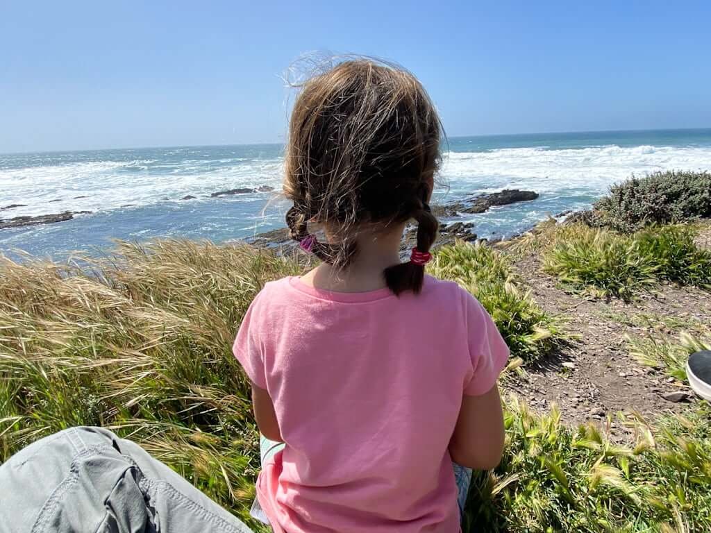 girl looking out over ocean