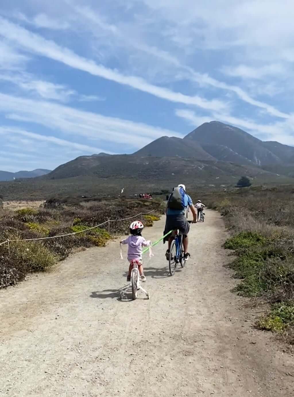 father and daughter riding bikes with bike bungee at Montana de Oro State Park trails