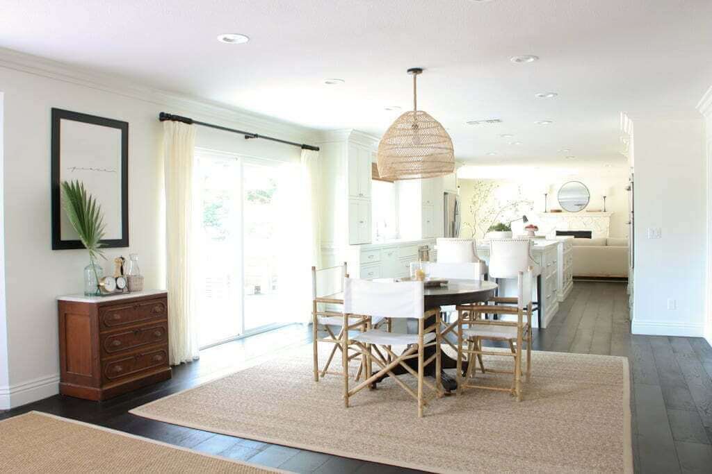 dining room and kitchen with dark wood floors and seagrass rugs