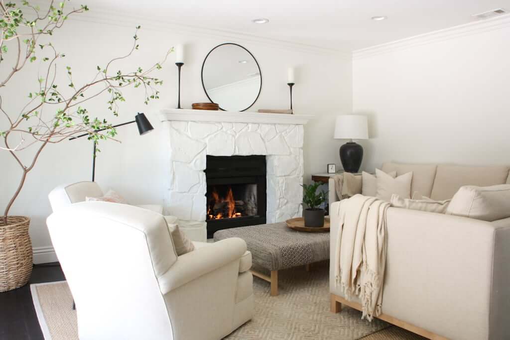 neutral living room with painted stone fireplace, neutral seating