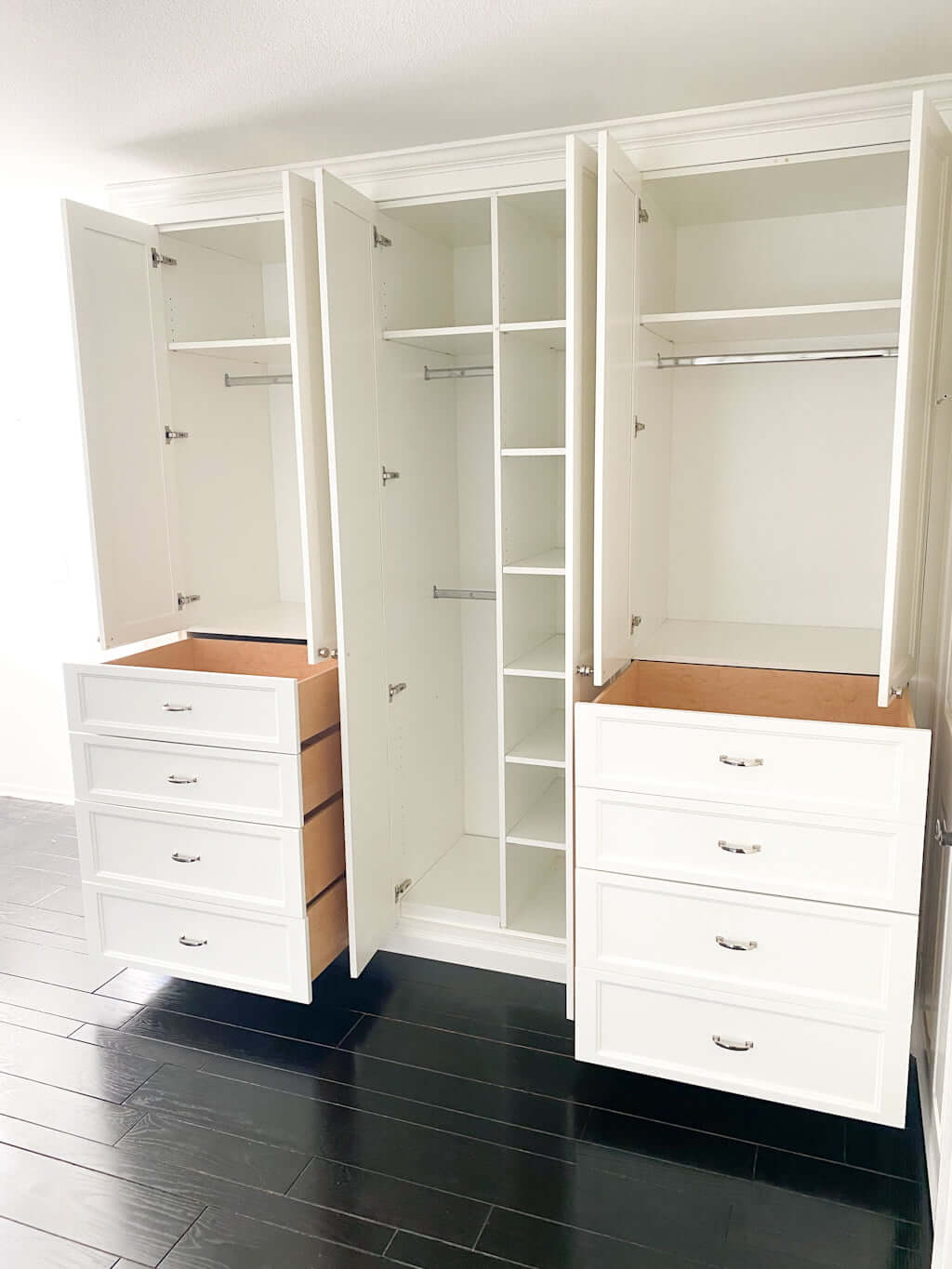built in closet drawers in wall, wardrobe space with hangers in bedroom