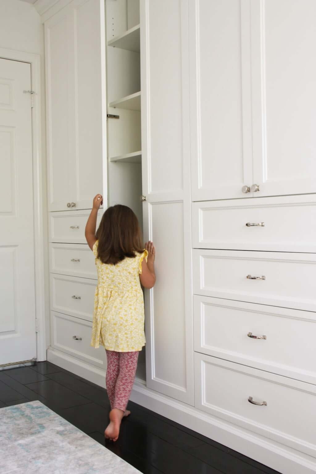 child opening built in closet cabinets