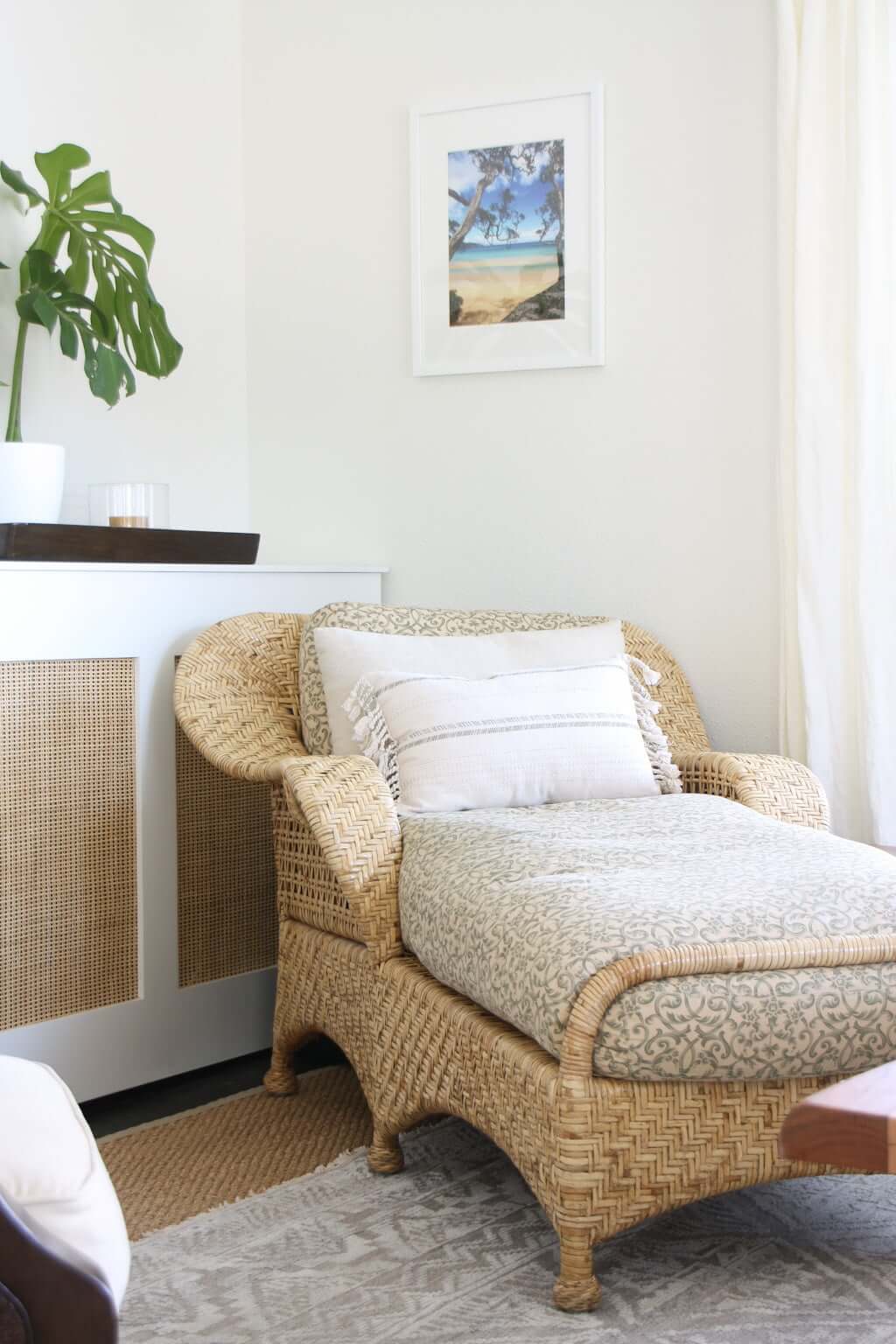 woven chaise with hidden tv cabinet behind it in corner