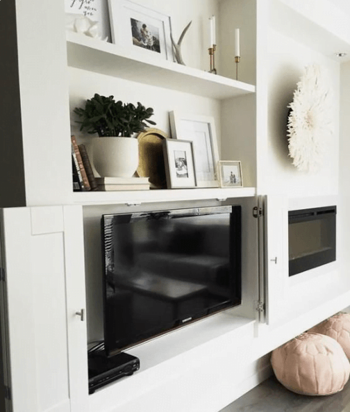 Folding Cabinet Doors to Hide TV Bookshelf next to fireplace