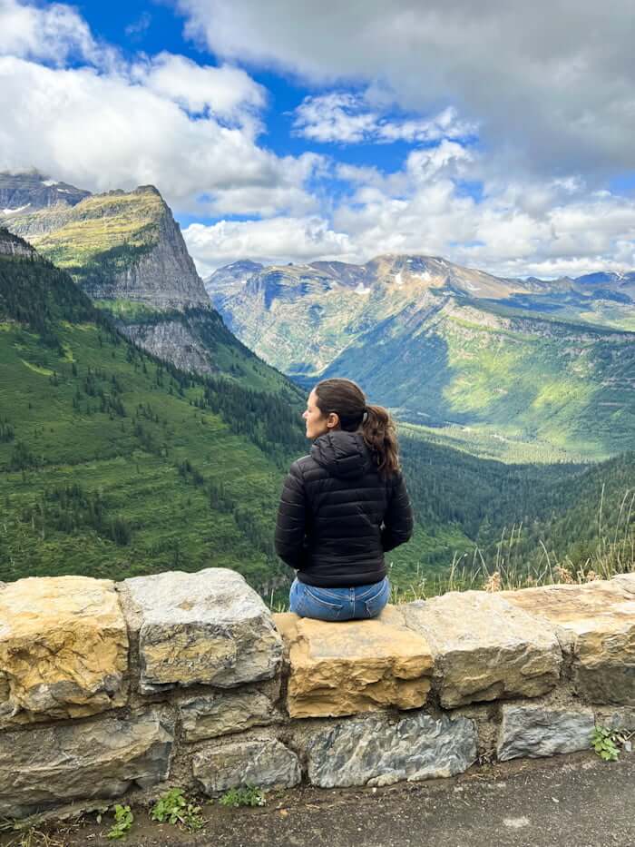 woman sitting along Going-to-the-Sun Road in Glacier National Park