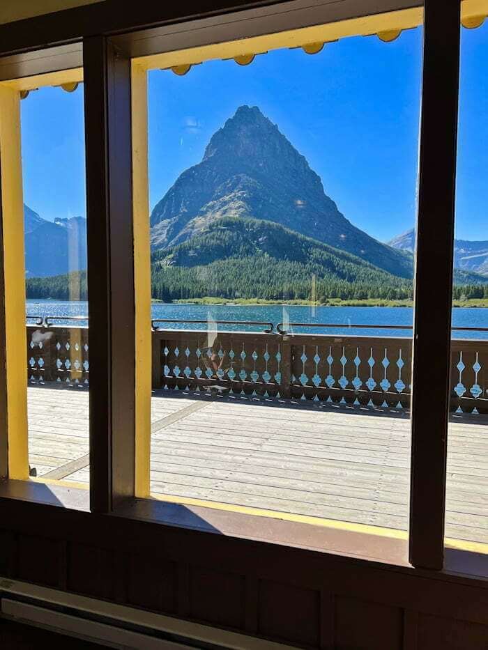 looking out windows from Many Glacier Hotel to lake and mountains in Glacier National Park