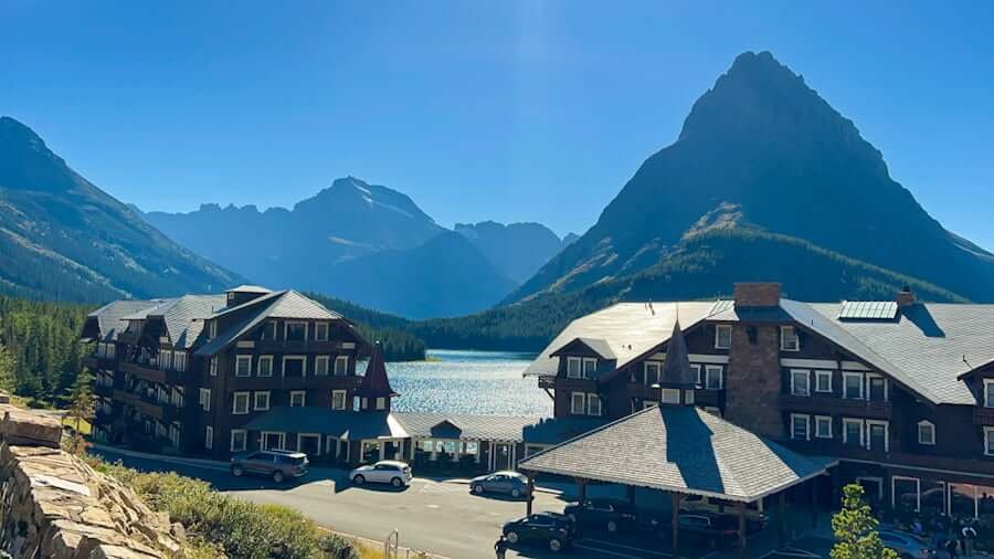 Many Glacier Hotel with lake and mountains in distance