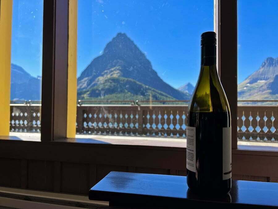 wine bottle at Many Glacier Hotel with mountains and lake in background