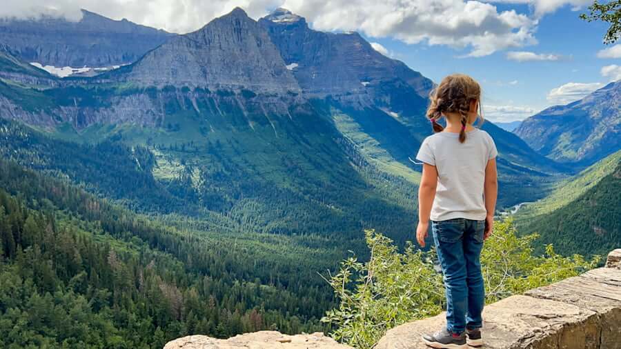 girl in Glacier National Park viewpoint with mountains