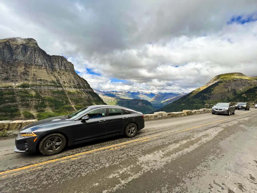 cars driving along the Going-to-the-Sun Road in Glacier National Park, Montana