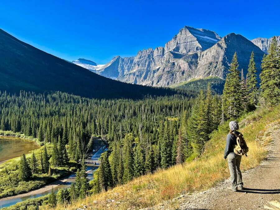 woman hiking Grinnell Glacier trail in Many Glacier in Glacier National Park 