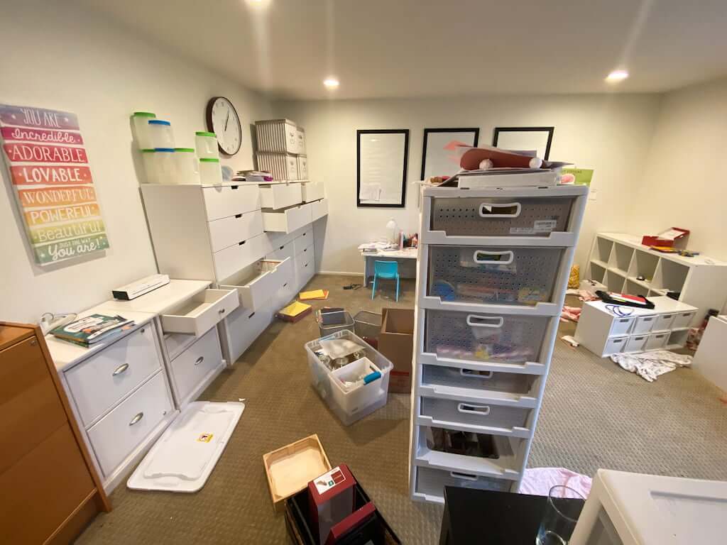 kids playroom being packed up for a move, messy with drawers