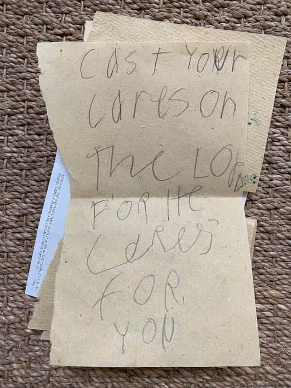 Child's handwritten note says "Cast your cares on the Lord for He cares for you"