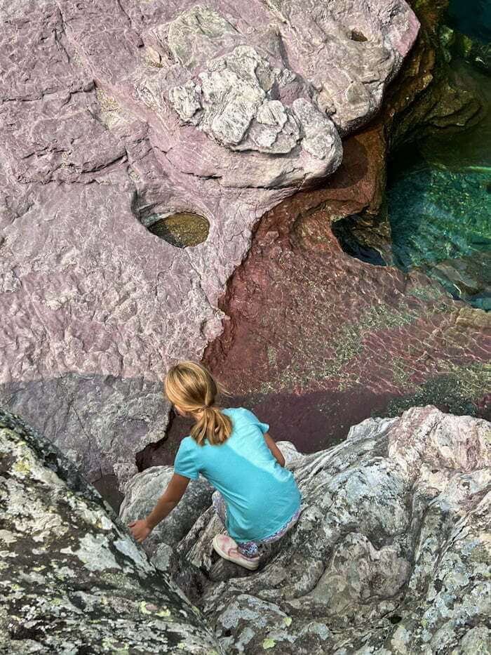 girl exploring in Glacier National Park creek