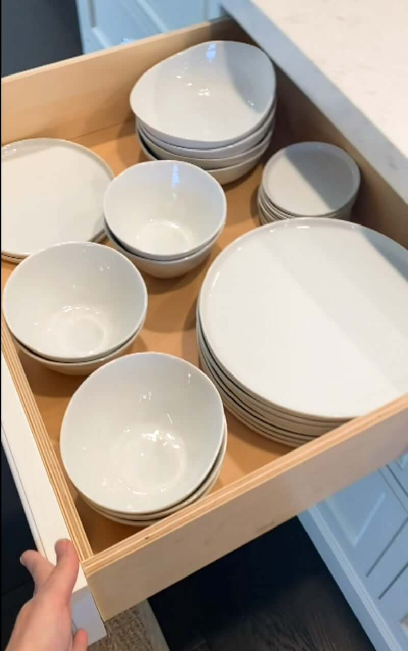 white plates stored in a drawer
