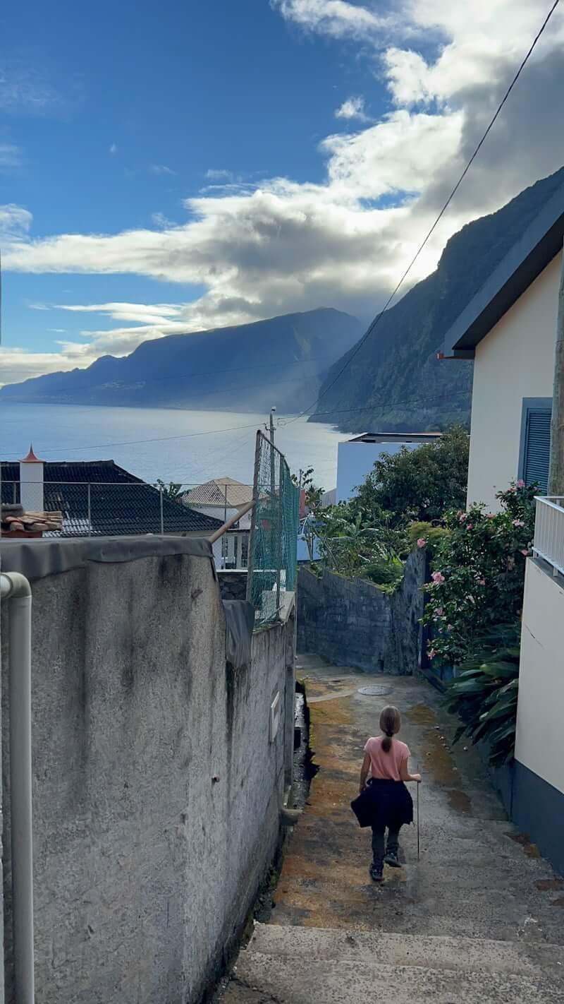 girl walking down narrow village street in Madeira Island, Portugal