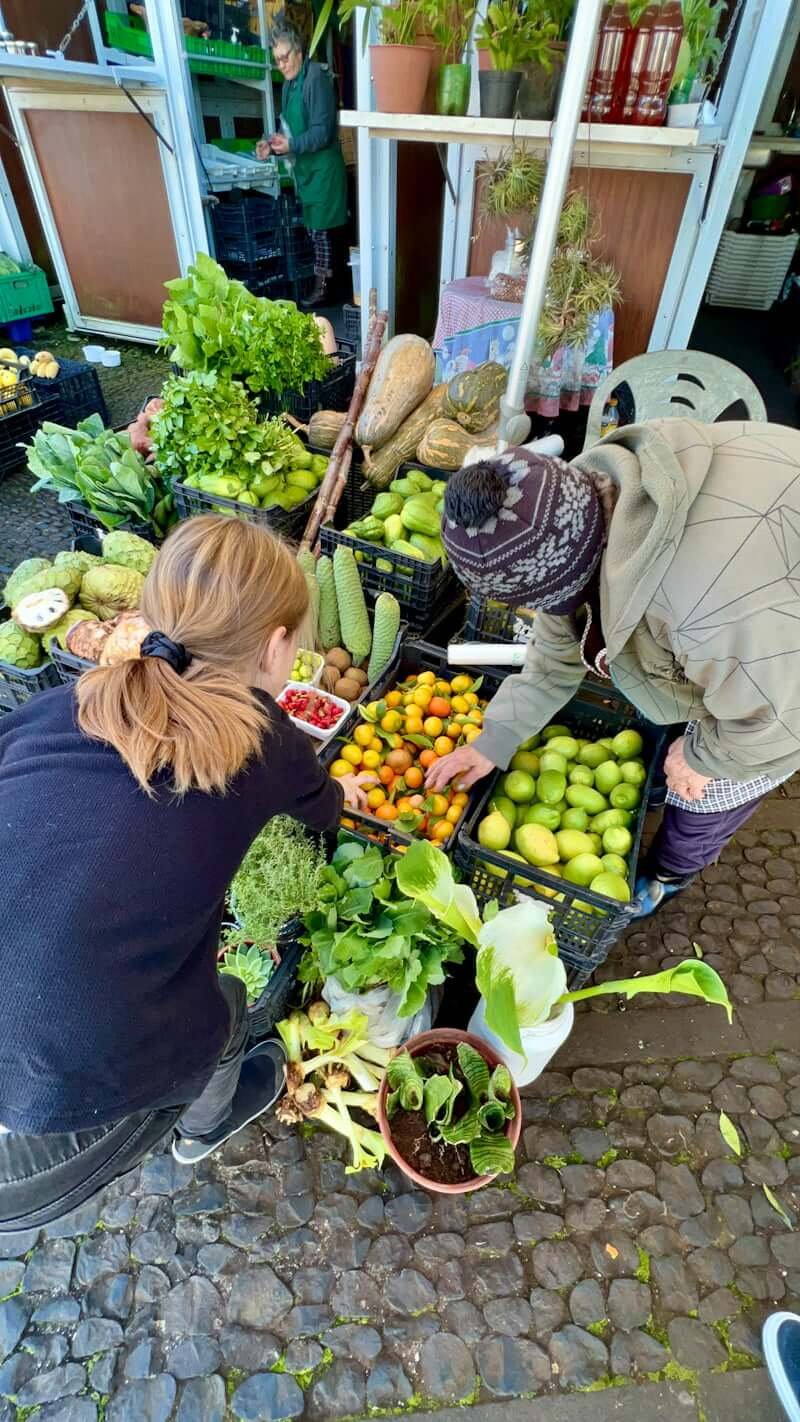 girl with old Portuguese woman in Madeira market