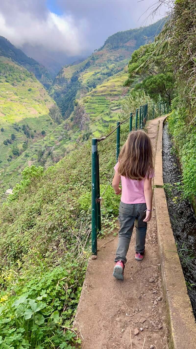 girl walking alongside levada in valley of Madeira