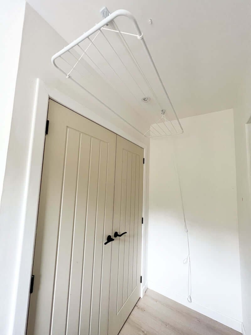 small laundry room with ceiling pulley for drying clothes rack