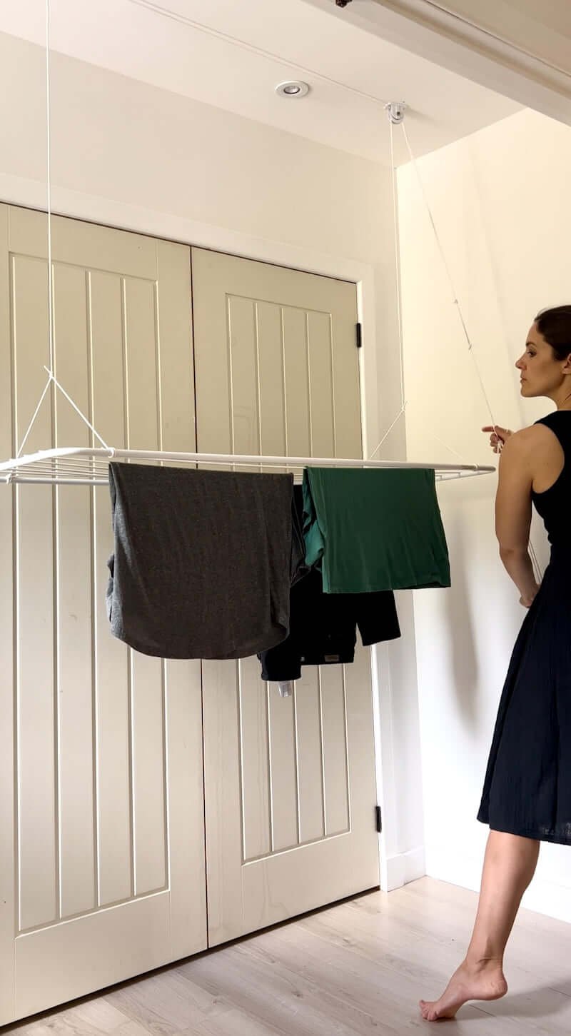 woman using laundry ceiling drying rack