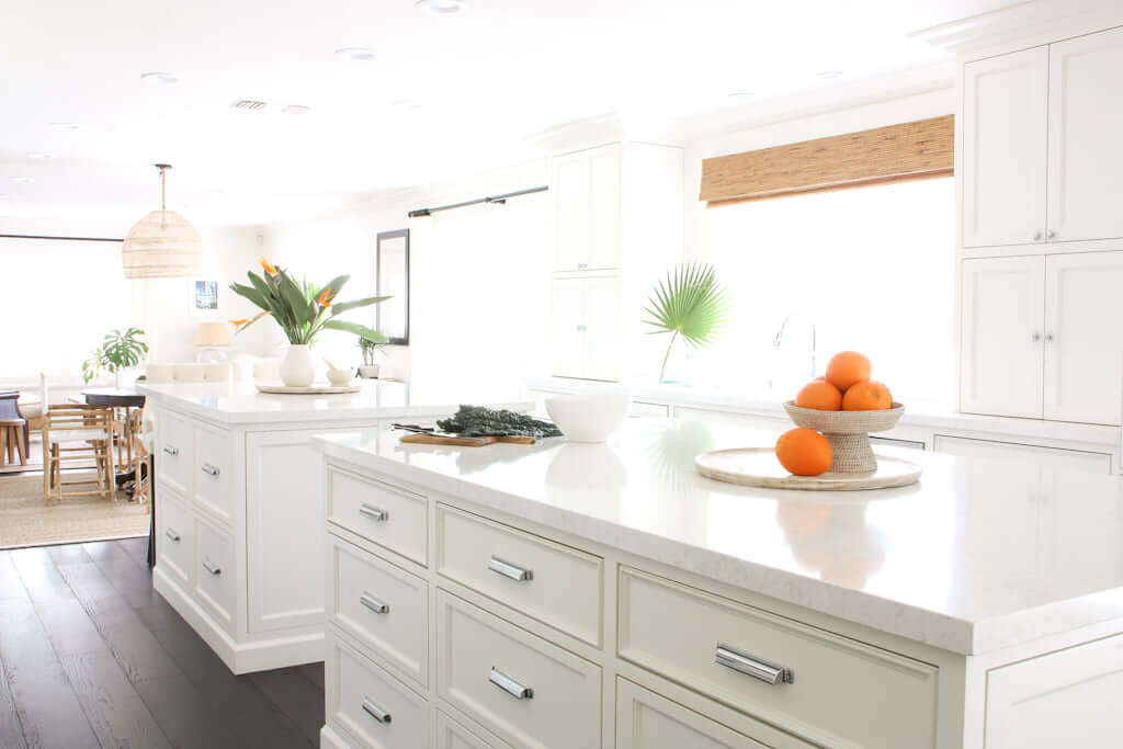 kitchen island height customized, two in kitchen with white quartz veined countertops, natural light and bright
