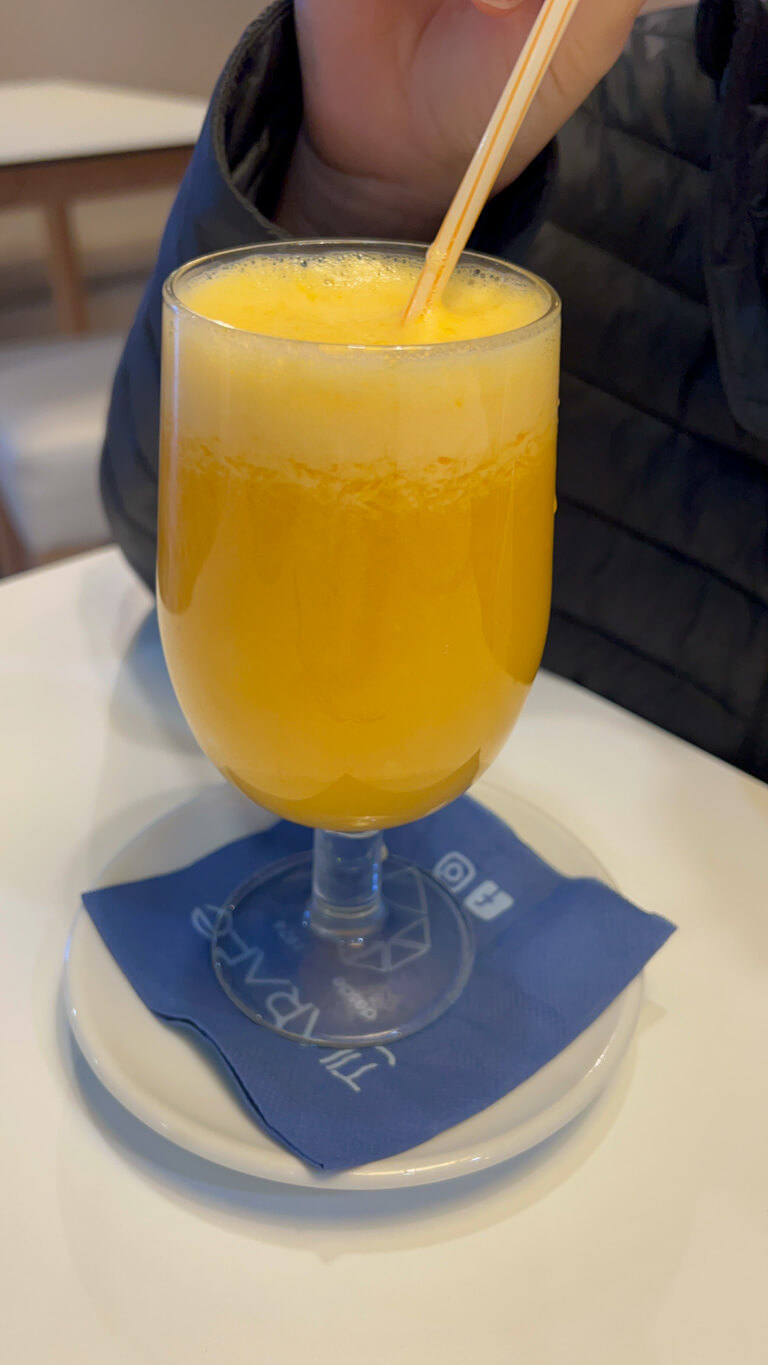 Glass of fresh orange juice with straw