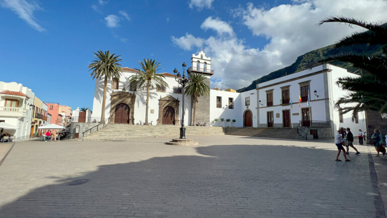 Tenerife Plaza with light post in middle and old church with palm trees  