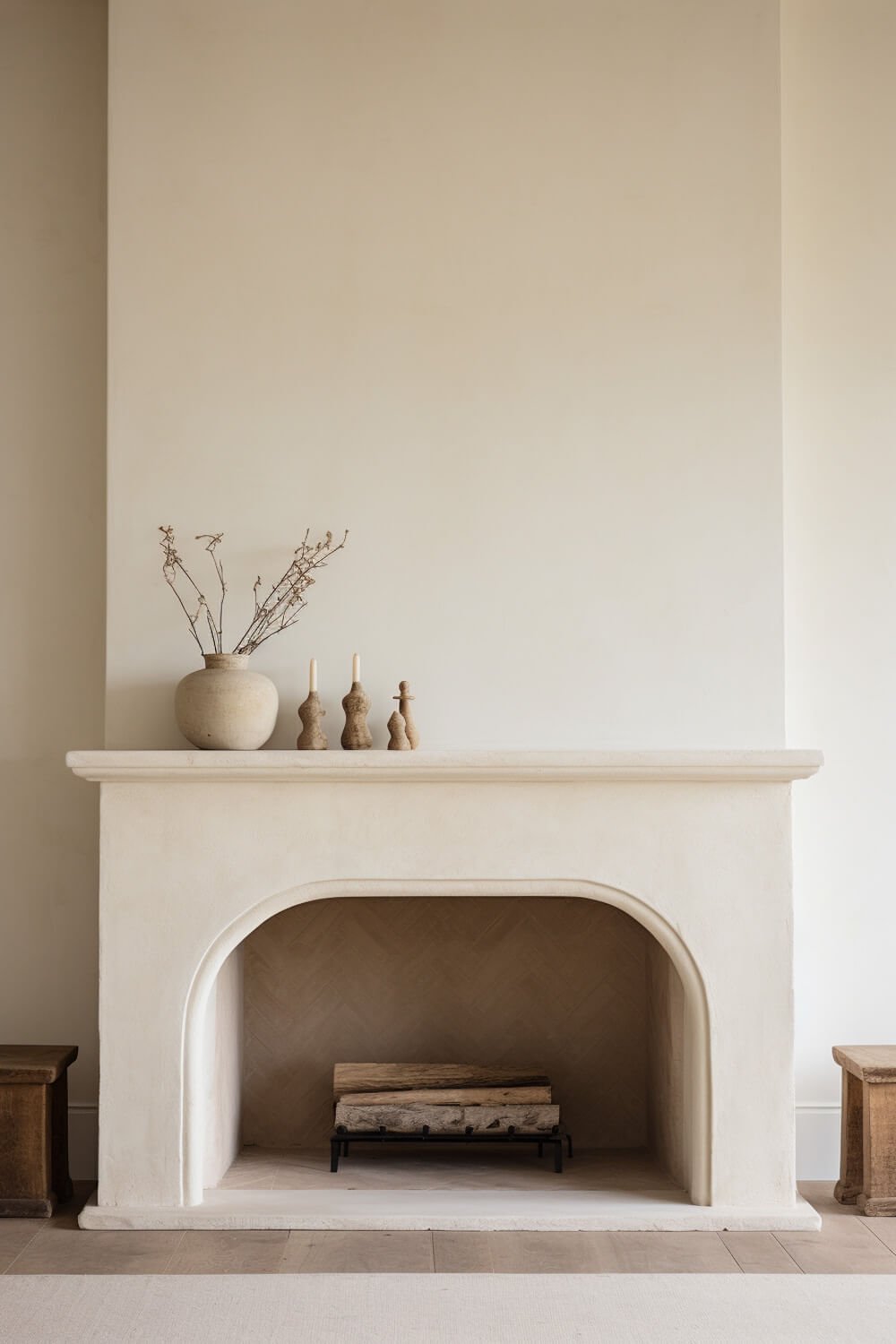 creamy plastered fireplace with arch and mantel