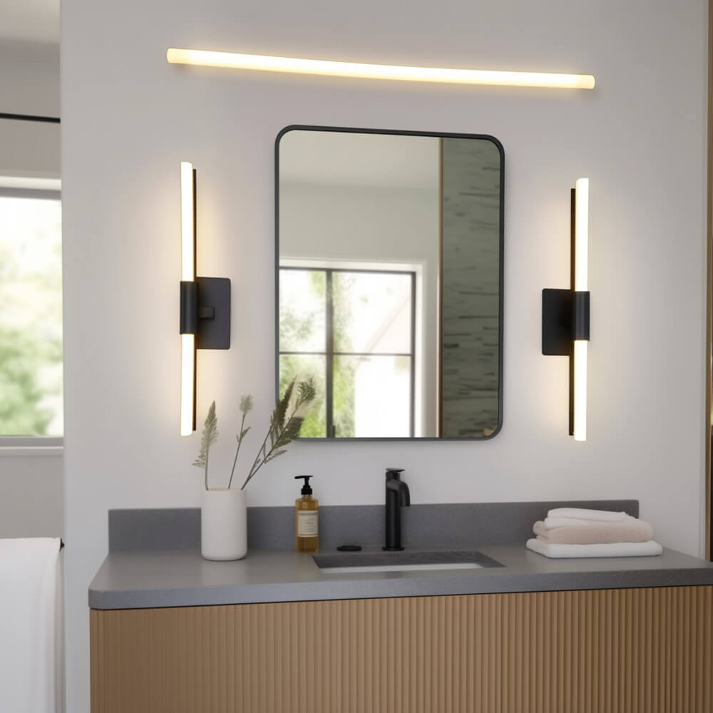 Bathroom light fixtures over mirror and on each side of the mirror with a modern wooden vanity below.