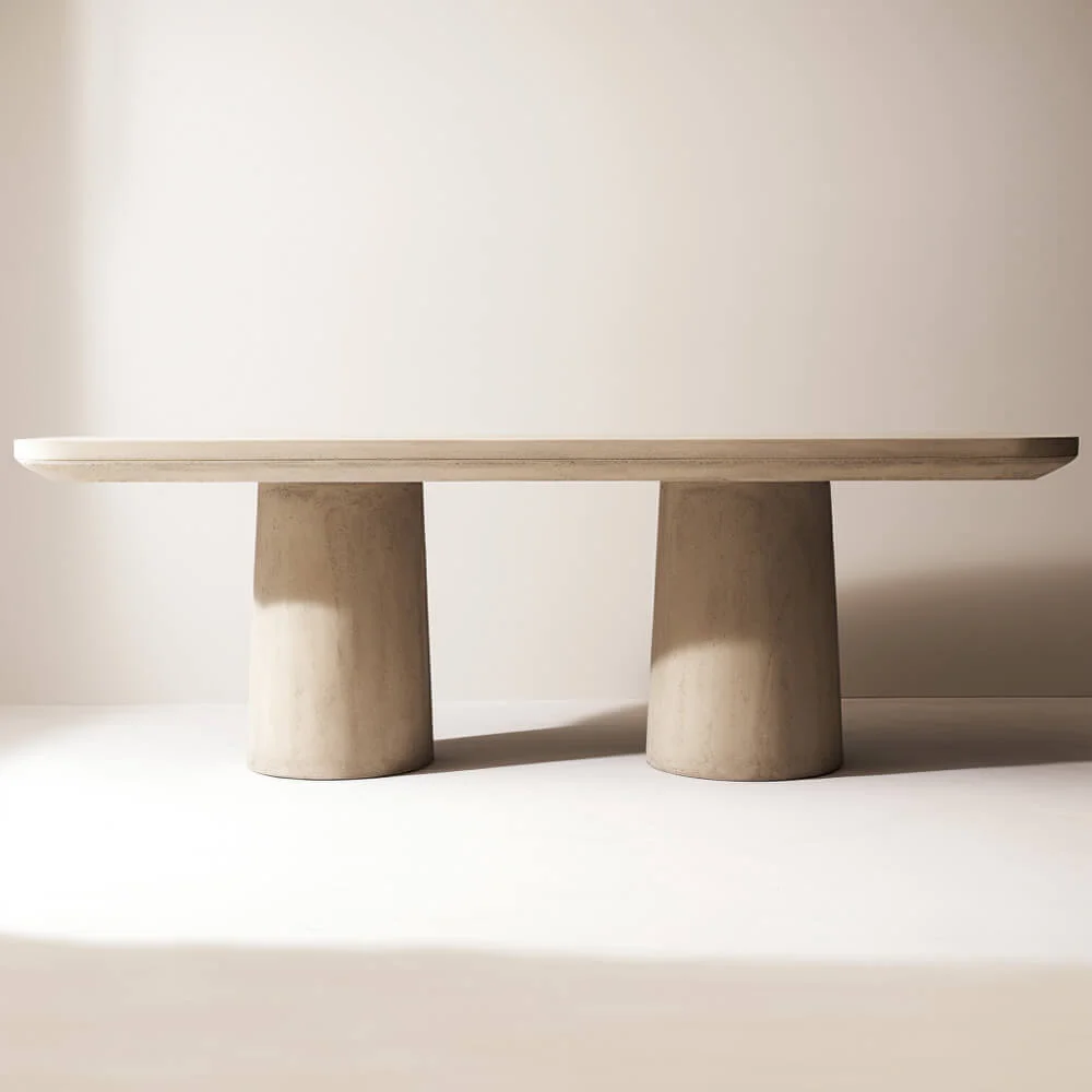 A plaster dining room table with a rectangular top and doulbe cylinder base