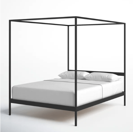 Black metal canopy bed frame design with white bedding.