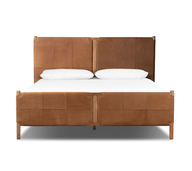 A wooden and leather bed frame idea with white bedding.