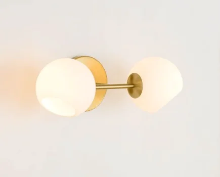 bathroom vanity lights gold. Gold light fixture with two round lights.