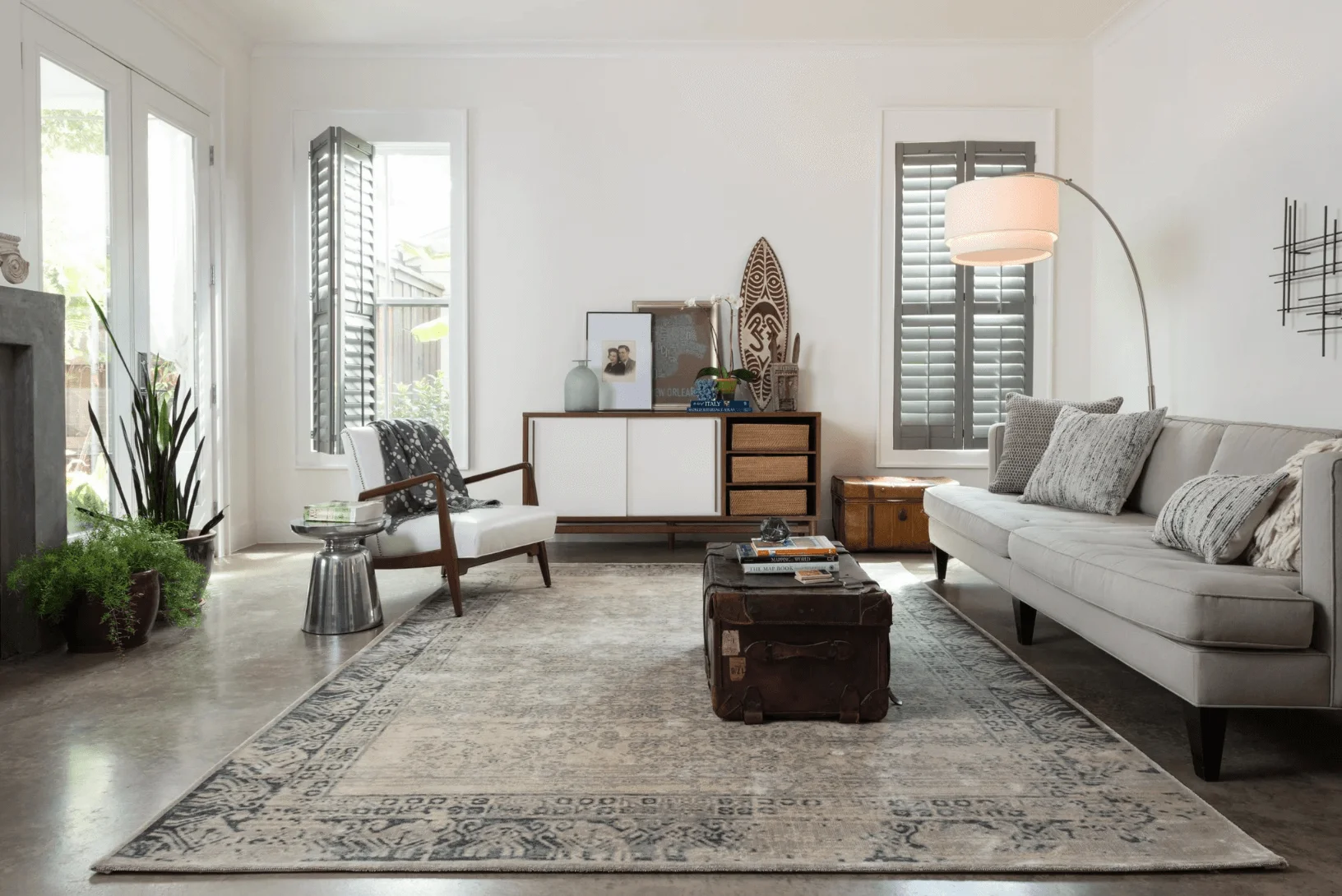 An example of a living room where the couch is not on the area rug but the armchair is. 