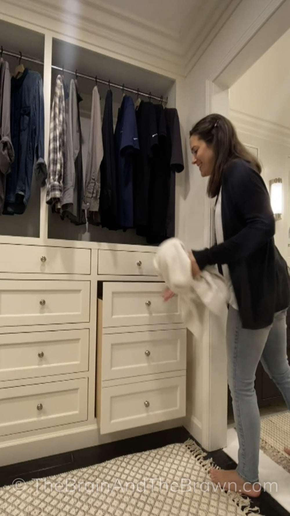 A women demonstrates where her hidden laundry hamper is within her closet.