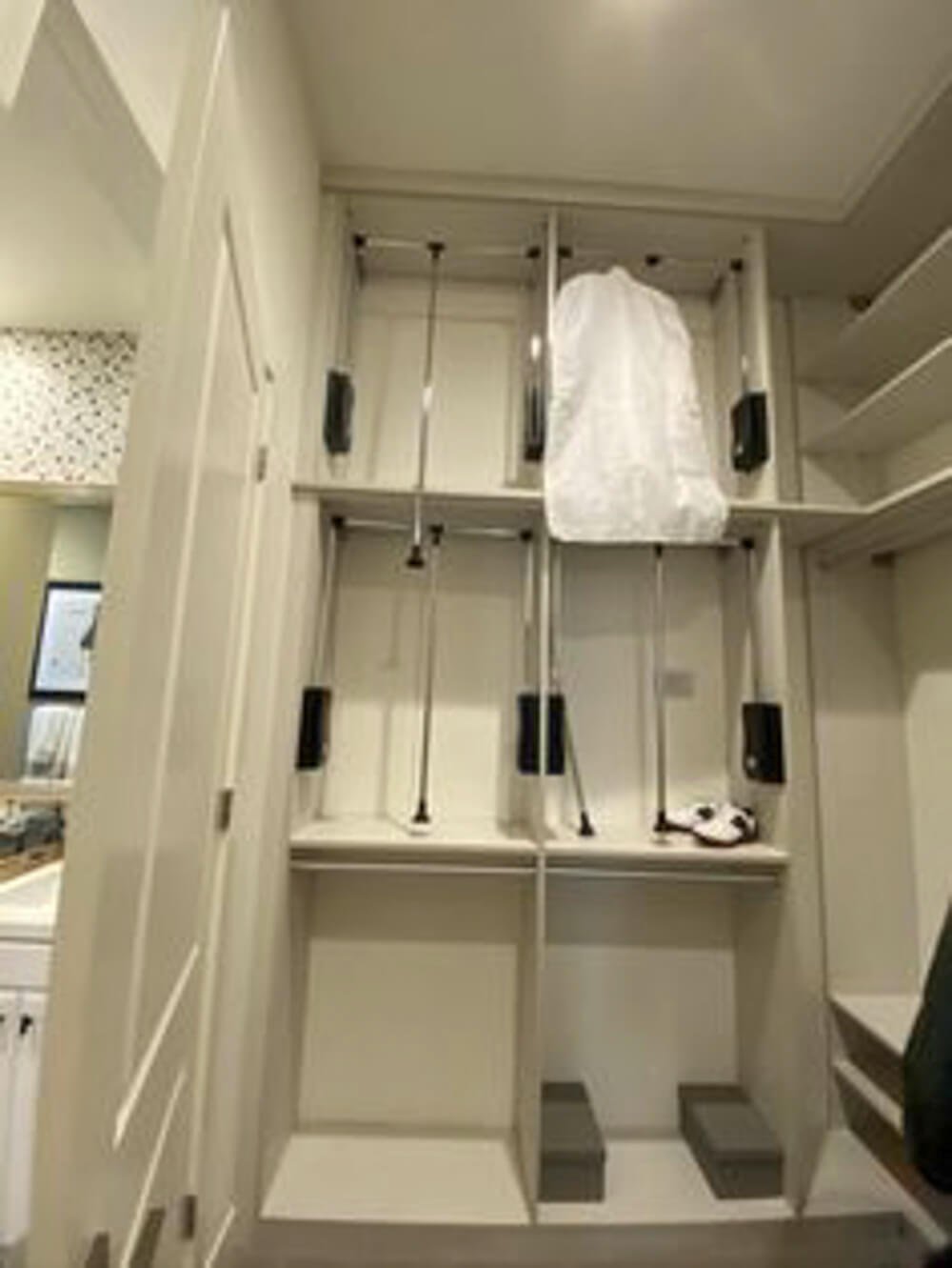 closet corner idea with pull down hanging rods