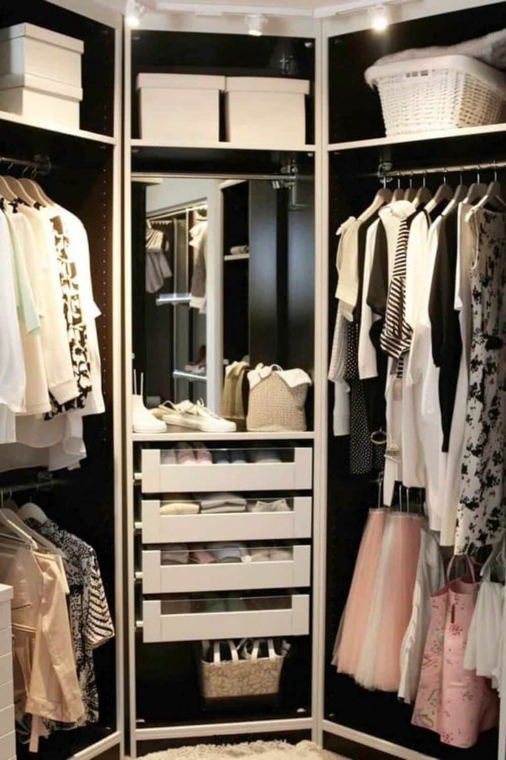 black and white walk in closet with corner drawers and corner shelf storage and mirror