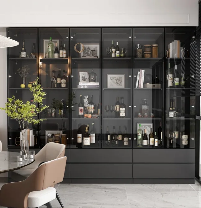 Black glass modern floor to ceiling bookshelves displayed with alcohol and décor in a dining room