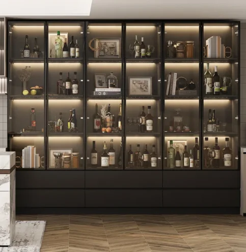 A black floor to ceiling bookshelf with glass doors and drawers 