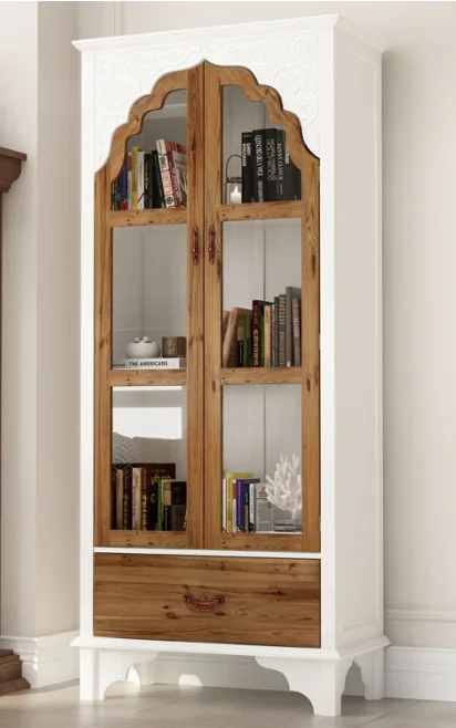 A white and wood cabinet with glass doors and a drawer 