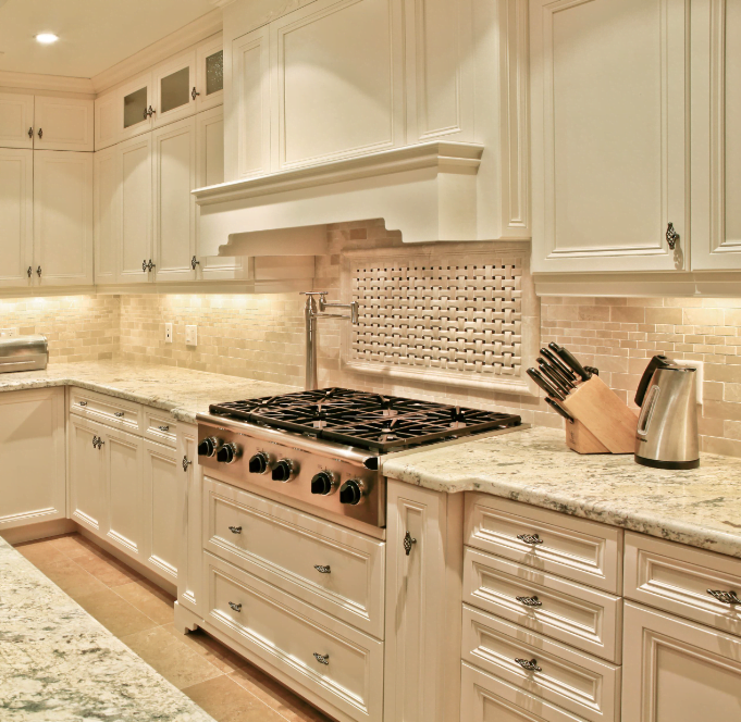 kitchen with beige backsplash, cabinets, and countertop and oil-rubbed bronze hardware