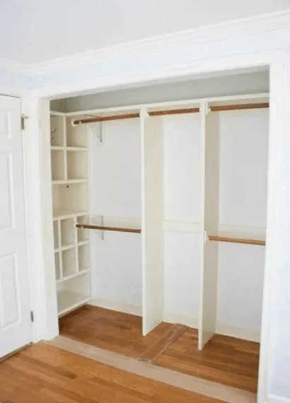 closet with hanging rods and shelves and cubes in closet corners