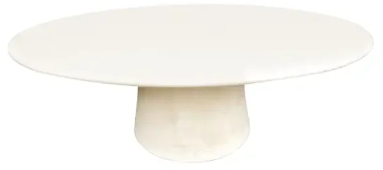 A round plaster dining table with singular round base. 