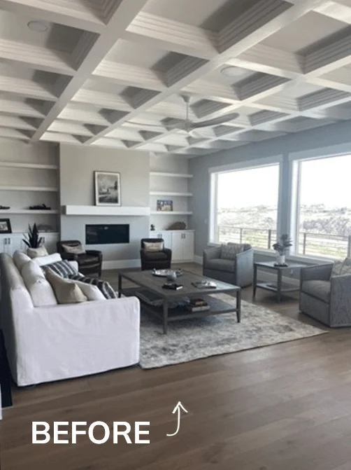 An awkward living room layout with fireplace. All furniture is pushed up against the walls and the rug is too small for the space.